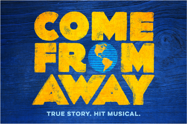 An image of the Come From Away logo. Come From Away is written in large, sunflower yellow text against a royal blue wooden background. The 'O' in FROM is replaced with an image of the Earth. Light blue text on the bottom says "True story. Hit Musical."